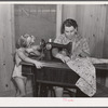 One of the project women making clothes for her family on her new sewing machine. Terrebonne Project, Schriever, Louisiana