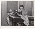 One of the project women making clothes for her family on her new sewing machine. Terrebonne Project, Schriever, Louisiana