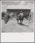 After the noon hour in the plantation yard, the mules, tractors and cultivators are taken out to finish the day's work. King and Anderson plantation, near Clarksdale. Mississippi Delta, Mississippi.