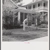 Man in front of his home weeding his lawn on Sunday. Natchitoches, Louisiana