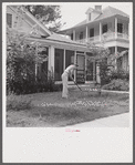 Man in front of his home weeding his lawn on Sunday. Natchitoches, Louisiana