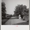 Melrose, Natchitoches Parish, Louisiana. [Multiracial person] returning home after buying supplies at country store