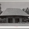 Melrose, Natchitoches Parish, LA. "African" house, probably a storeroom, smokehouse or jail when originally built by [multiracial people], now part of John Henry cotton plantation. He bought it from the Metoyier family in 1833. It was built and owned by them