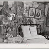 Melrose, Natchitoches Parish, Louisiana. Bedroom with religious pictures, etc. on mud walls of old hut built and still occupied by French [multiracial people], near John Henry cotton plantation. Belongs to Rocque family (see general caption)