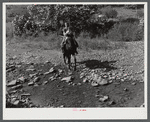 Mountain woman and child travel almost entirely by horseback as the creek beds are still the only roads in some sections. They live up Burton's Fork off Middle Fork of the Kentucky River. Breathitt County, Kentucky.