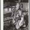 Mountain woman and grandchild sitting on the porch of their home up Frozen Creek, Breathitt County, Kentucky.