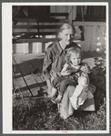 Mountain woman and grandchild sitting on the porch of their home up Frozen Creek, Breathitt County, Kentucky.