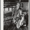 Mountain woman and grandchild sitting on the porch of their home up Frozen Creek, Breathitt County, Kentucky.