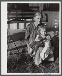 Mountain woman and grandchild sitting on the porch of their home up Frozen Creek, Breathitt County, Kentucky.