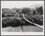 Carrying home groceries and supplies across the swinging bridge, Breathitt County, Jackson, Kentucky.