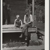 Mountaineer with his grandson whom he raised in his home with the help of the neighbors. He had been crippled with arthritis most of his life. On the steps of a schoolhouse at South Fork of Kentucky River. Breathitt County, Kentucky.