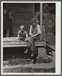 Mountaineer with his grandson whom he raised in his home with the help of the neighbors. He had been crippled with arthritis most of his life. On the steps of a schoolhouse at South Fork of Kentucky River. Breathitt County, Kentucky.