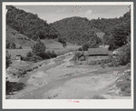 General landscape near Hyden, Kentucky showing mountain cabins, sheds and cornfields.