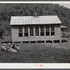 Children eating lunch during noon hour by one-room rural mountain school. Breathitt County, Kentucky.