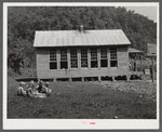 Children eating lunch during noon hour by one-room rural mountain school. Breathitt County, Kentucky.