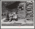 Mountain family on porch of their home made of hand hewn logs up South Fork of Kentucky River, Breathitt County, Kentucky.