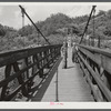 Miners' children crossing swinging bridge from their homes into town. Hazard, Kentucky.