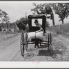 Farmer taking home sack of feed on the back of his buggy. Saturday afternoon near Lexington, Kentucky.