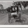 Farmer taking home sack of feed on the back of his buggy. Saturday afternoon near Lexington, Kentucky.