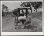 Farmer taking home sack of feed on the back of his buggy. Saturday afternoon near Lexington, Kentucky.