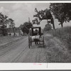 Farmer taking home sack of feed on the back of his buggy. Saturday afternoon near Lexington, Kentucky.