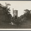 View of Grangebel Park and yellow brick tower. Tower was built about 1880 as part of gristmill by Judge Timothy Griffing (d.1924). Riverhead, Riverhead