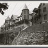 View of houses on enbankment above street. Hempstead, Hempstead