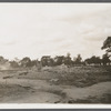 View of foundation remains of building with cemetery in background. Rockville Centre, Hempstead