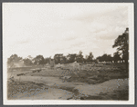 View of foundation remains of building with cemetery in background. Rockville Centre, Hempstead