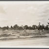 View of foundation remains of building with cemetery in background. Rockville Centre, Hempstead