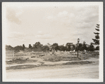 View of foundation remains of building with cemetery in background. Rockville Centre, Hempstead