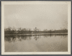 View of Artist Lake. Looking southwest from Middle Country Road. Formerly Glover's Pond, alias Curran's Pond. Boathouse in center. Middle Island, Brookhaven