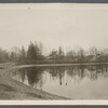 View of Artist Lake. Looking southeast from Middle Country Road. Formerly Glover's Pond, alias Curran's Pond. Former church in center. Middle Island, Brookhaven