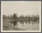 View of Artist Lake. Looking southeast from Middle Country Road. Formerly Glover's Pond, alias Curran's Pond. Former church in center. Middle Island, Brookhaven