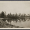 View of Artist Lake. Looking southeast from Middle Country Road. Formerly Glover's Pond, alias Curran's Pond. Former church on left. Middle Island, Brookhaven