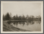 View of Artist Lake. Looking southeast from Middle Country Road. Formerly Glover's Pond, alias Curran's Pond. Former church on left. Middle Island, Brookhaven