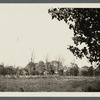 View of house behind fence and trees. North of North Hempstead Turnpike. Greenvale, Oyster Bay