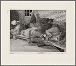 Farmers sleeping in [Black] camp room in warehouse. They often must remain overnight or several days before their tobacco is auctioned. Several of them are using an old tobacco basket for a pillow. Durham, North Carolina.