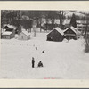 Children sleigh riding down hill in center of town. Woodstock, Vermont.