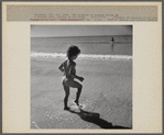 Daughter of parents living at Sarasota trailer park, Sarasota, Florida, playing in the water at the beach.