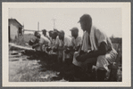 Men in baseball uniforms on bench
