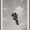 Man in uniform climbing barb wire