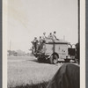 Men in uniform on top of military truck