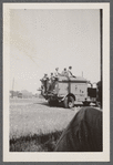 Men in uniform on top of military truck
