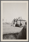 Men in uniform at military truck