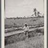 Man in uniform standing by barb wire