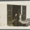 Two women standing at an outdoor table