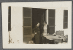 Two women standing at an outdoor table