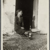 Woman seated in a doorway