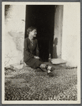 Woman seated in a doorway